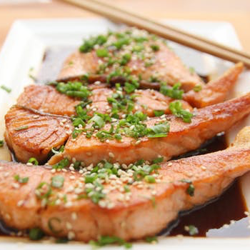 a picture of cooked salmon in soy sauce on a plate